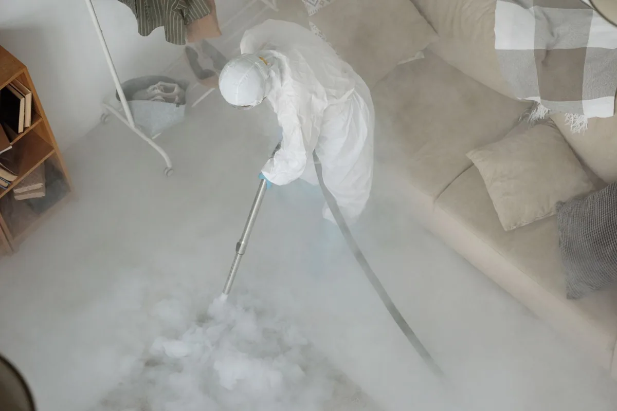 Biohazard cleanup technician in protective equipment, Atoka, NM